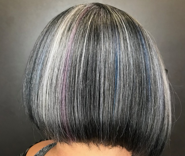 Middle aged woman with grey hair transformation in salon