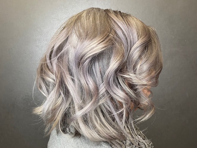 woman with stunning silver colored hair in salon