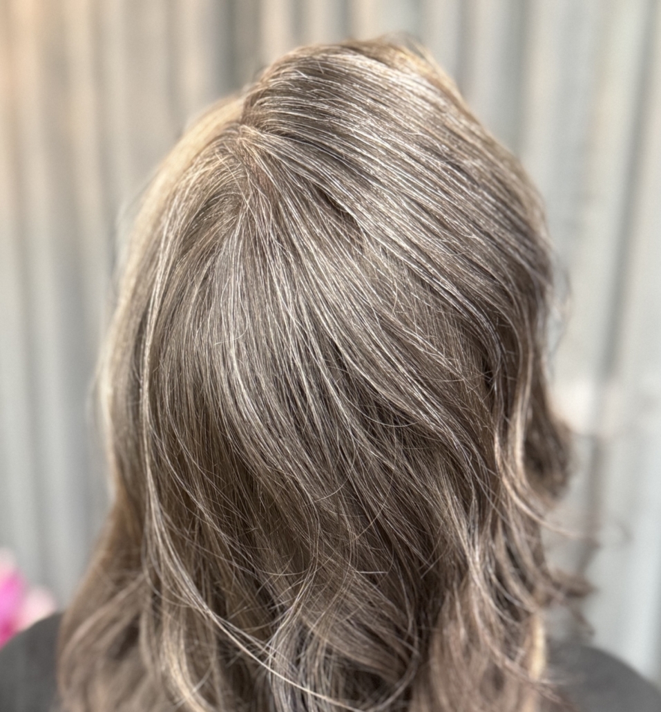 woman with perfect grey-blending colored hair in salon