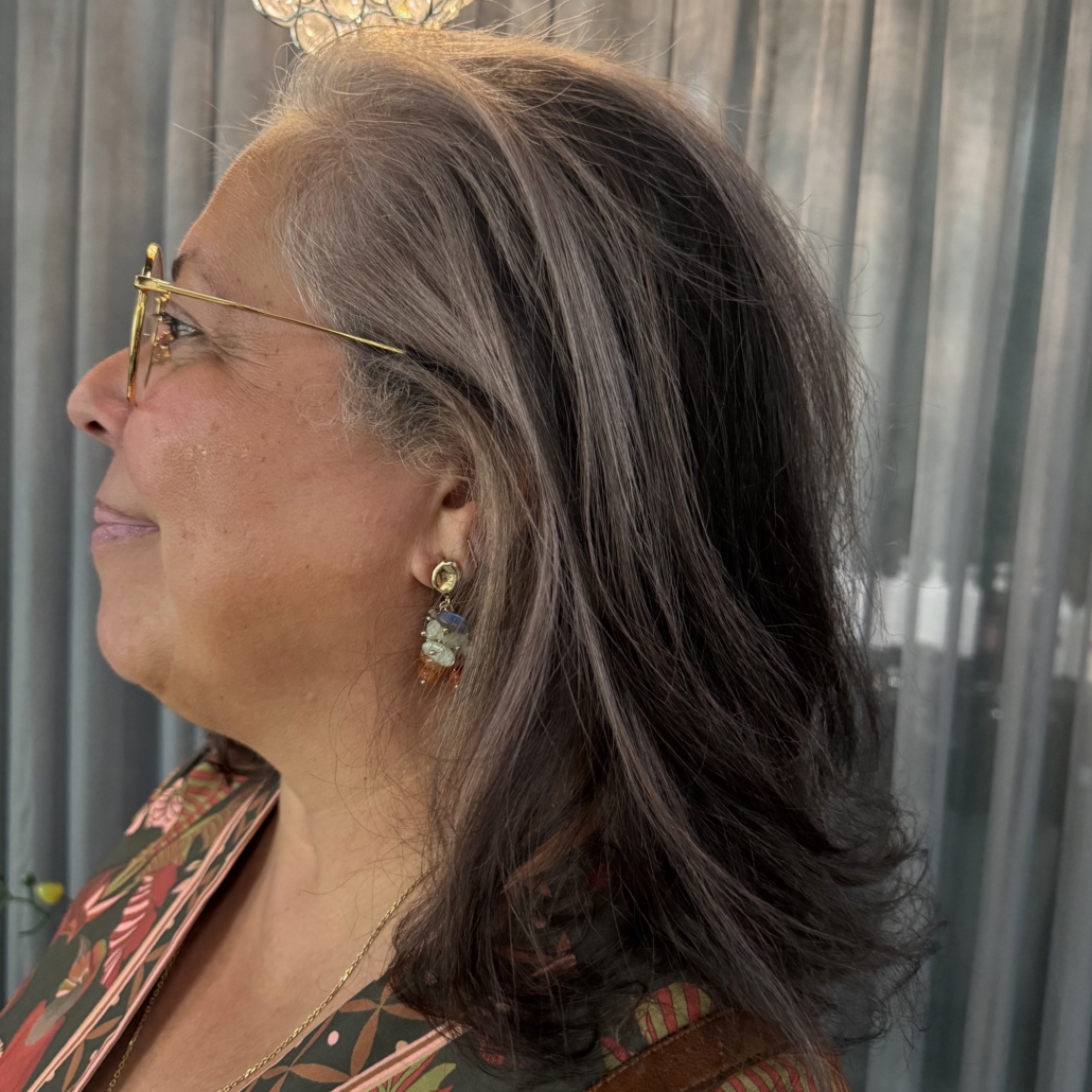 middle aged woman with wavy grey and brown coloured hair in salon