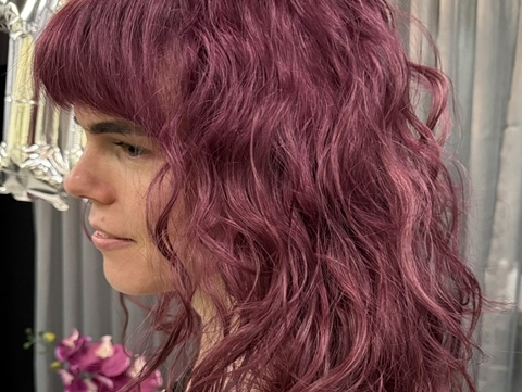 woman with pink coloured hair in salon