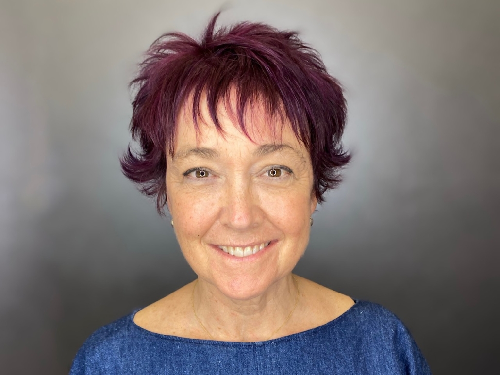 middle aged woman with short ruby hair in salon