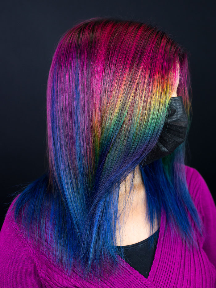 woman wearing mask with multi-coloured hair in salon pulp riot