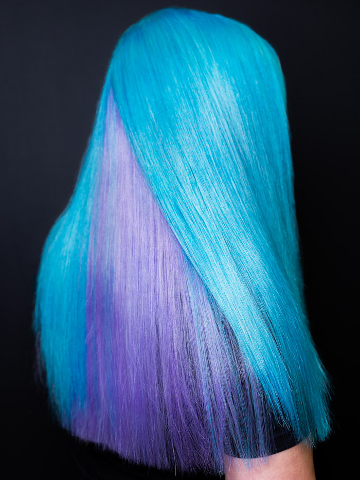 woman with blue and purple colored straight hair in salon pulp riot