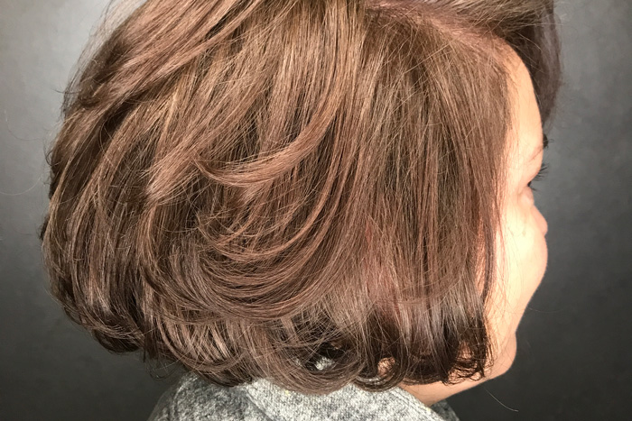 woman with brown colored hair in salon