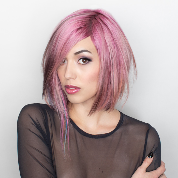 young woman with light pink hair colour in salon