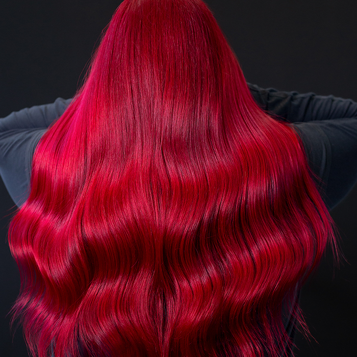 Woman with rich ruby red hair and a velvety finish, coloured using Danger Jones hair colour.